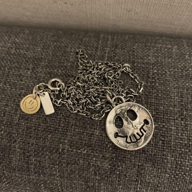 Silver coin smiling face skull pendant